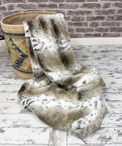 A striking animal design fur throw in a warm beige, with additional stripes of creamy off-white and taupe spots