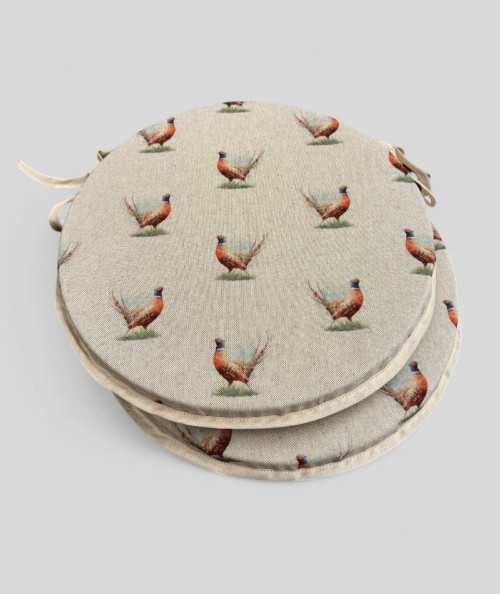 Extra thick linen style round chair pads in a small pheasant design on a beige base