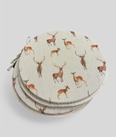 Round linen style seat pads with a brown stag and deer design