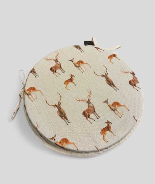Round linen style chair pads with a brown stag and deer design