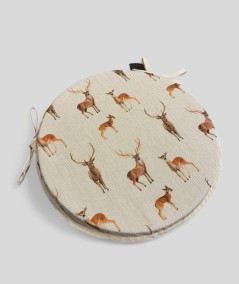 Round linen style chair pads with a brown stag and deer design