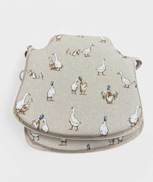 Modern shaped seat pads in a natural linen beige with a modern white duck print