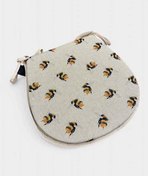 Classic D shaped seat pads in beige linen with a small bee print