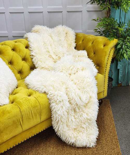 Luxury long, curly haired cream faux fur sofa throw